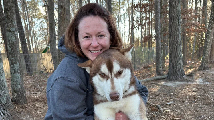 Volunteer with a rescued dog at Rides 4 Paws Rescue, an animal rescue nonprofit partner